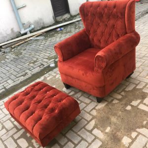 Burnt orange accent chair with leg rest