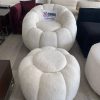 Off-white bouclé round sofa with a matching pouffe