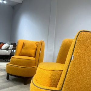 Accent chairs made with yellow boucle fabric.