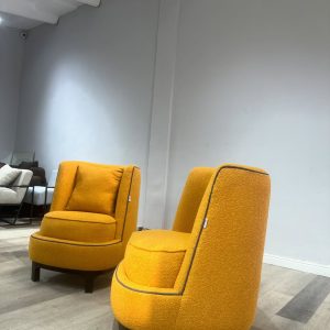 Accent chairs made with yellow boucle fabric.