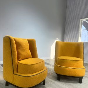 Accent chairs made with yellow boucle fabric.