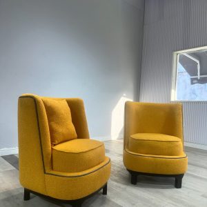Accent chairs made with yellow boucle fabric.