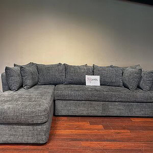 Dark grey 6-seater sectional sofa features plush backrests.